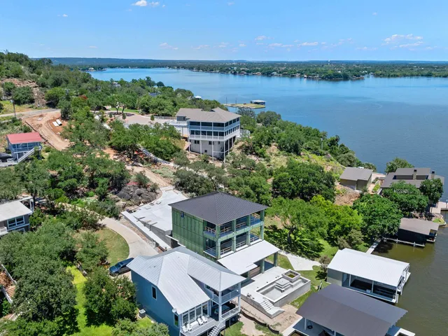 an aerial view of residential houses with outdoor space and swimming pool