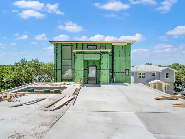 a backyard of a house with garden and outdoor seating