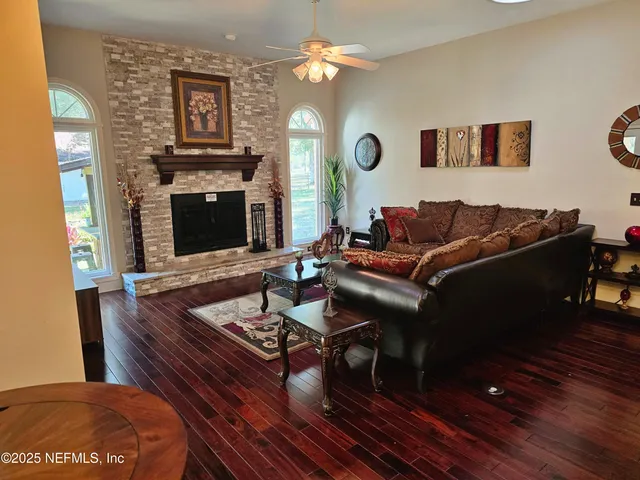 a living room with furniture a fireplace and a flat screen tv