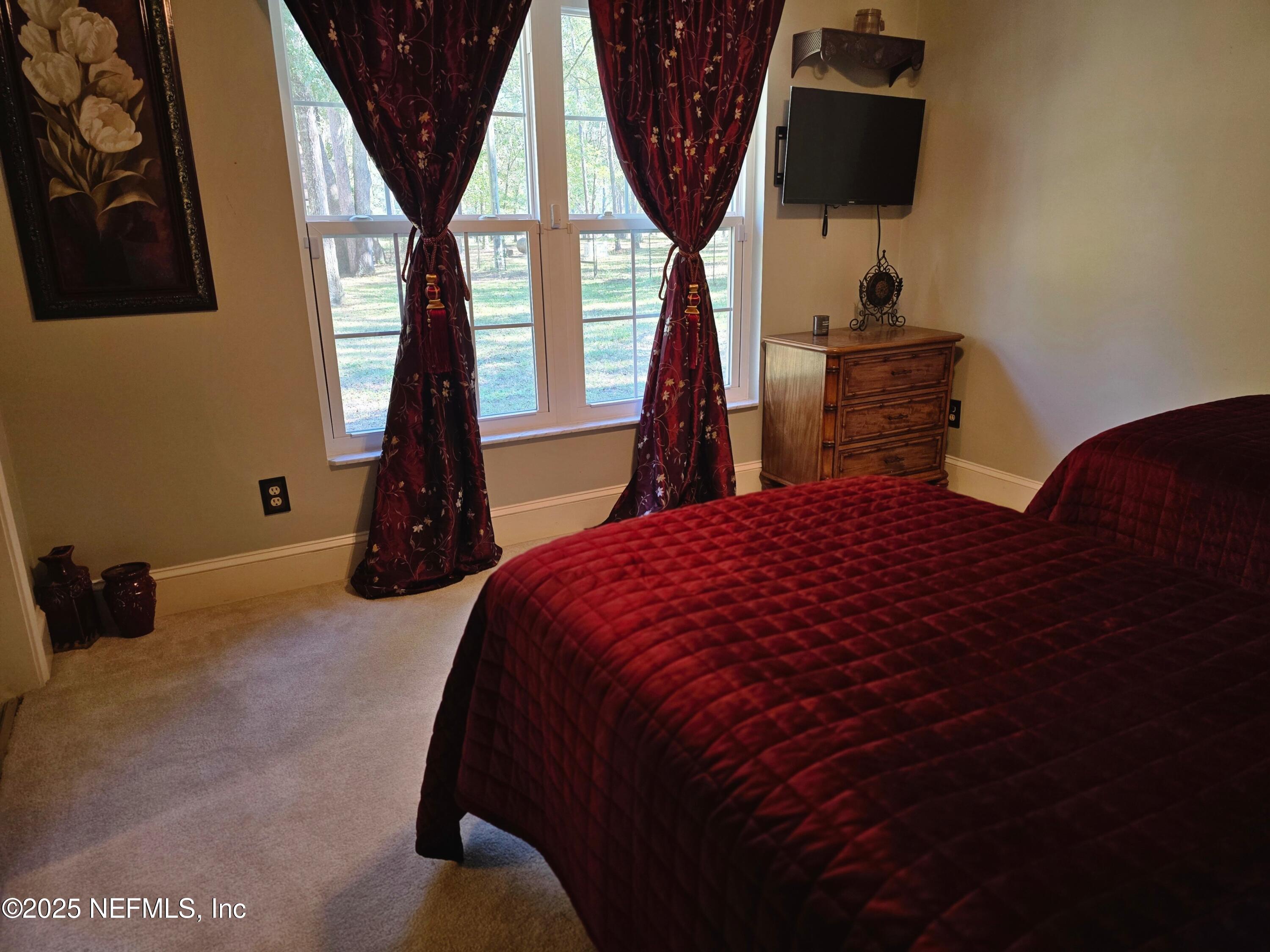 3600 Stratton Road Jacksonville, FL 32221 - Photo 5 of 10 a bed sitting in a bedroom next to a window