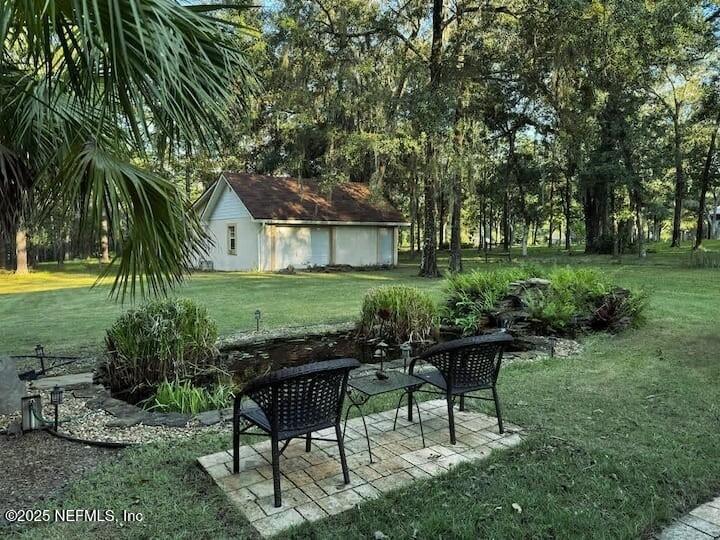 3600 Stratton Road Jacksonville, FL 32221 - Photo 9 of 10 a view of a backyard with table and chairs potted plants and large tree