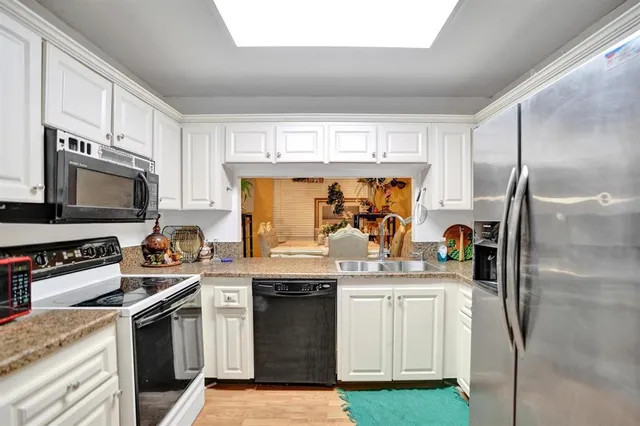 a kitchen with a sink stove and refrigerator