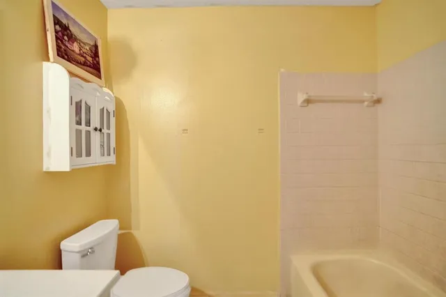 a bathroom with a toilet and a sink