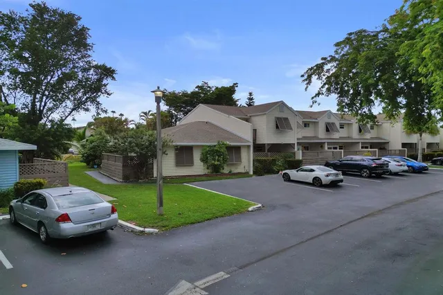 a couple of cars parked in front of a house