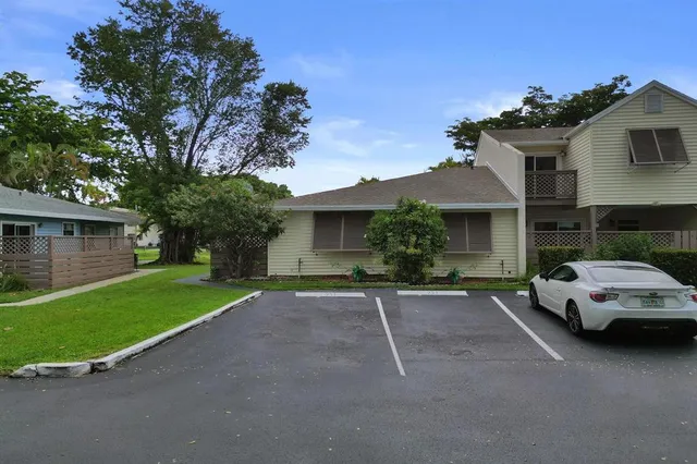 a car parked in front of a house with a yard