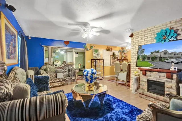 a living room with furniture a fireplace and a table