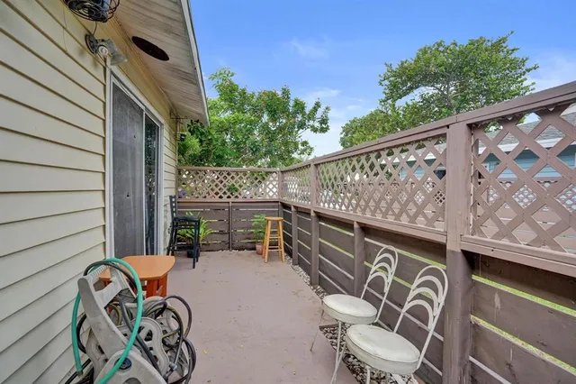 a view of a chairs and table in patio