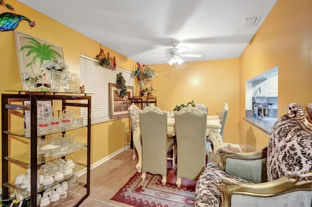 a living room with furniture and a painting on the wall