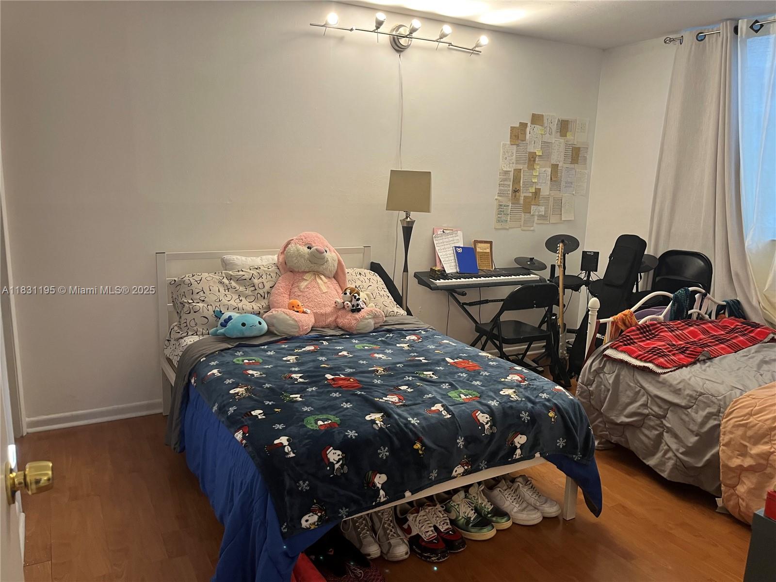 8251 Northwest 8th Street, Unit 214 Miami, FL 33126 - Photo 12 of 19 a bedroom with bed and a window