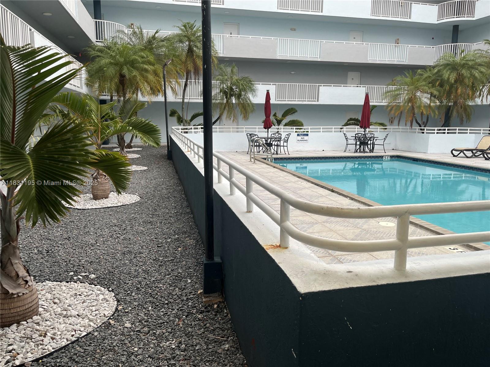 8251 Northwest 8th Street, Unit 214 Miami, FL 33126 - Photo 15 of 19 a kitchen with a sink a counter top space and cabinets