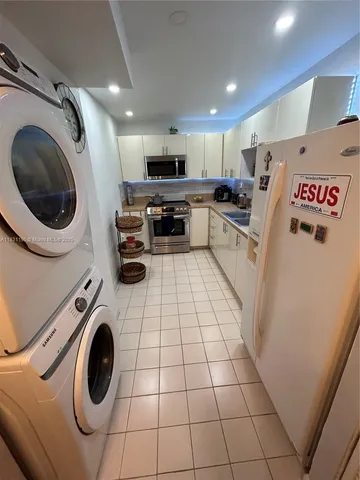 a kitchen with a sink a washer and dryer