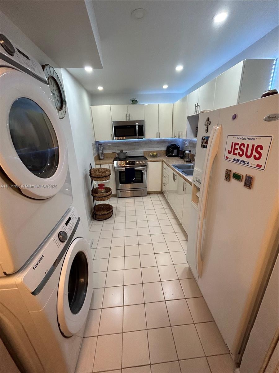 8251 Northwest 8th Street, Unit 214 Miami, FL 33126 - Photo 2 of 19 a kitchen with a sink a washer and dryer