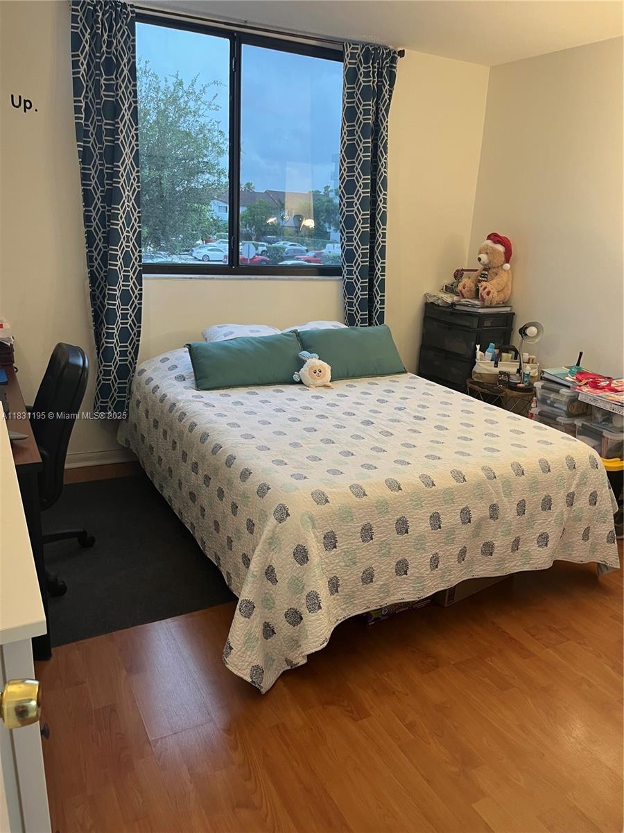 8251 Northwest 8th Street, Unit 214 Miami, FL 33126 - Photo 10 of 19 a bedroom with a bed and a window