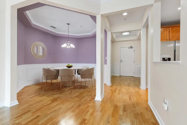 a view of a dining room with a table and chairs