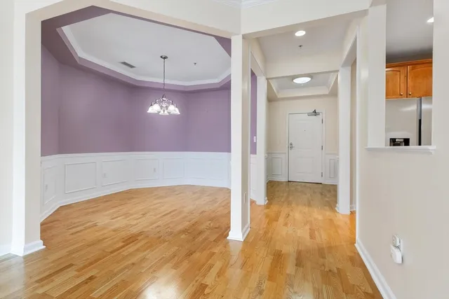 a view of a livingroom with wooden floor and a sink