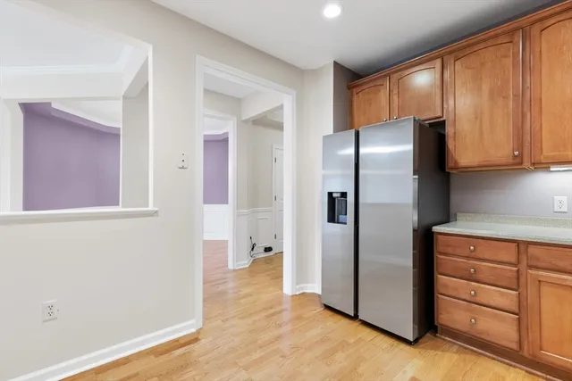 a kitchen with stainless steel appliances granite countertop a refrigerator and a sink