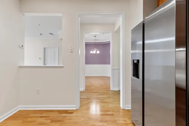 a view of a hallway with wooden floor