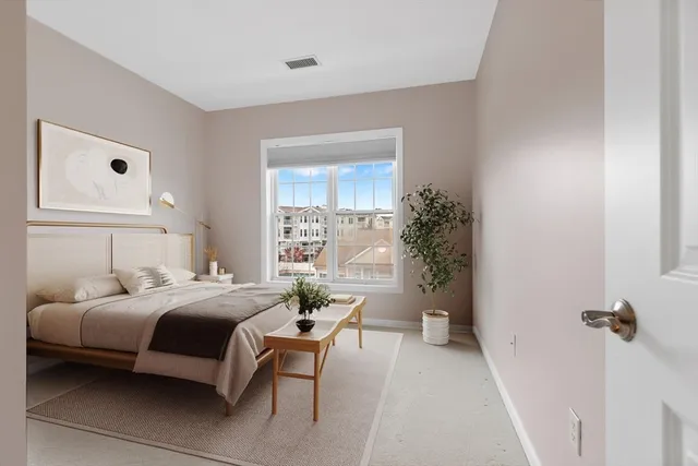 a bedroom with a bed furniture and a window