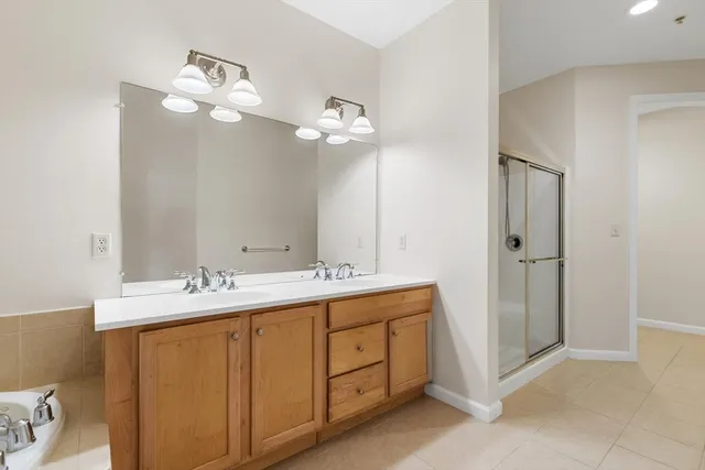 a bathroom with a double vanity sink and a mirror