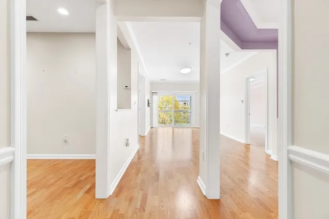 a view of a hallway with wooden floor