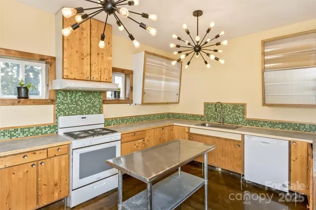 a kitchen with a cabinets a sink and appliances