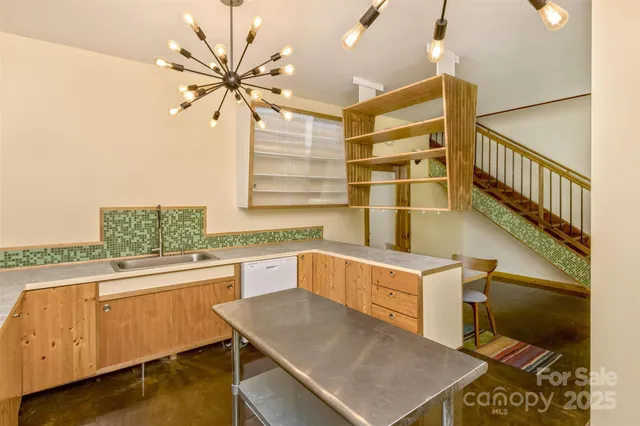 a kitchen with a sink and a stove top oven