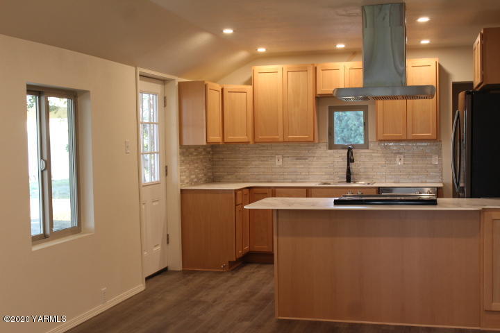 440 Gurley Road Granger, WA 98932 - Photo 7 of 25 a kitchen with stainless steel appliances granite countertop a sink a stove and a refrigerator
