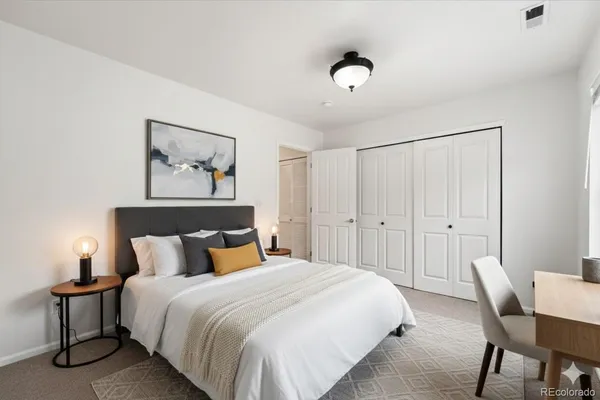 a bedroom with a bed and a lamp