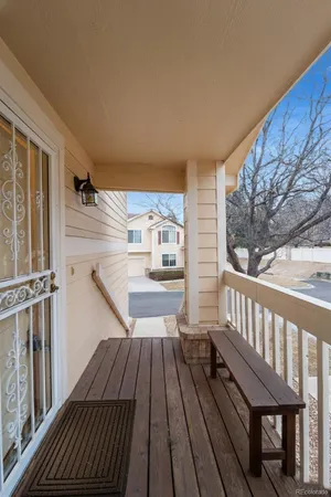 a view of balcony with wooden floor and outdoor seating