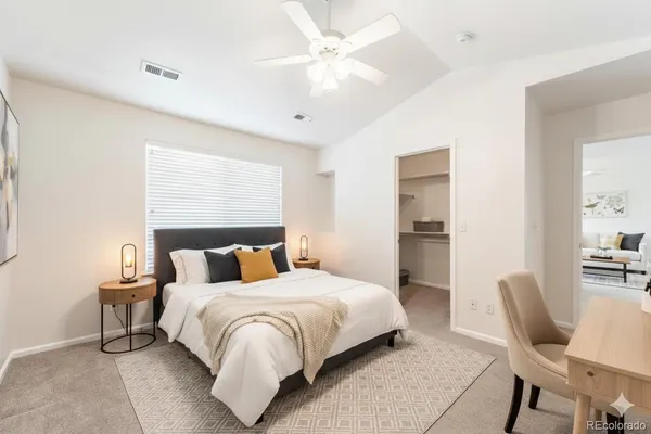 a bedroom with a bed and a chair