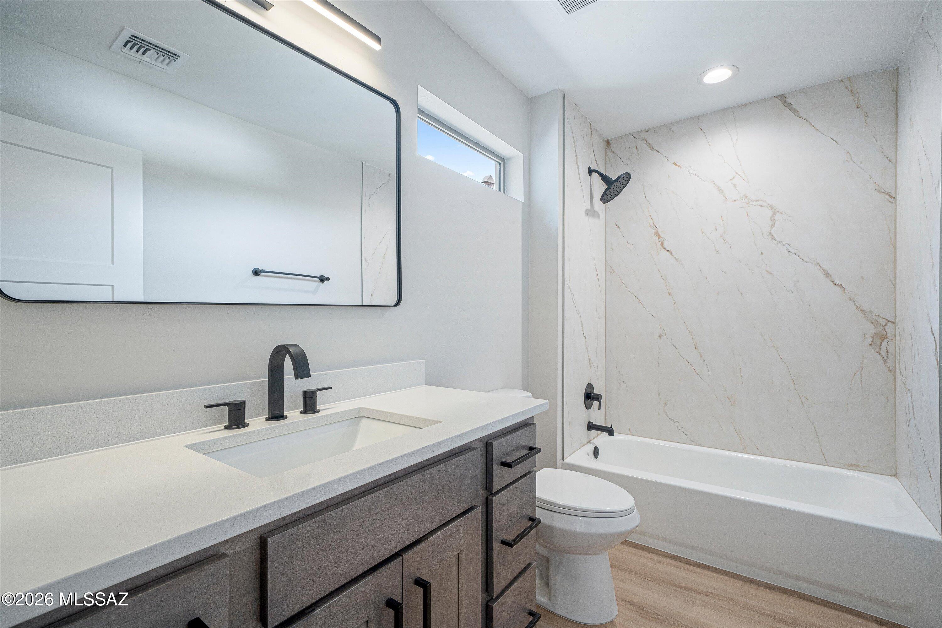 739 North Queen Avenue, Unit 2 Tucson, AZ 85705 - Photo 14 of 28 a bathroom with a sink a toilet and shower
