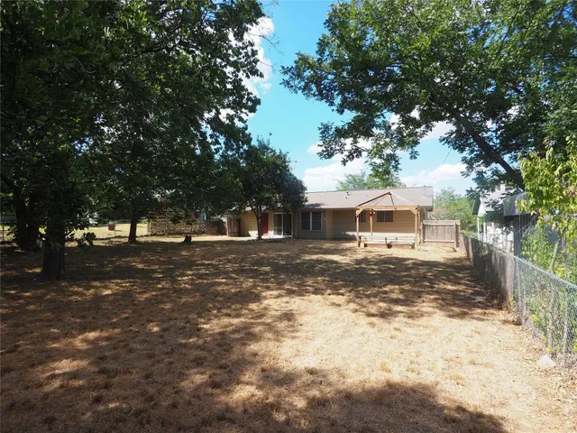 a view of a yard with a house in the background