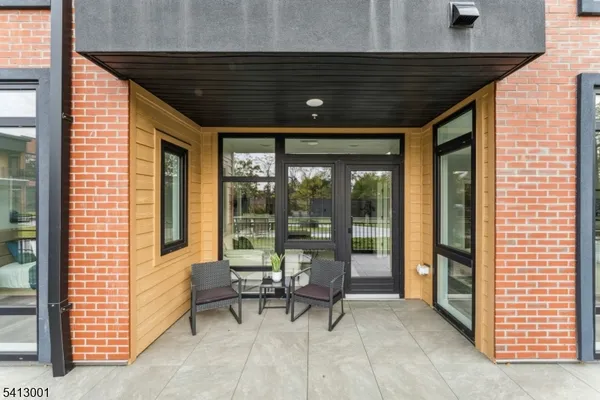 a view of a patio with a table and chairs and floor to ceiling window