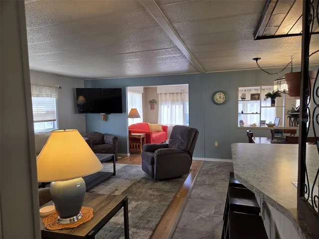 a kitchen with a dining table chairs and white cabinets