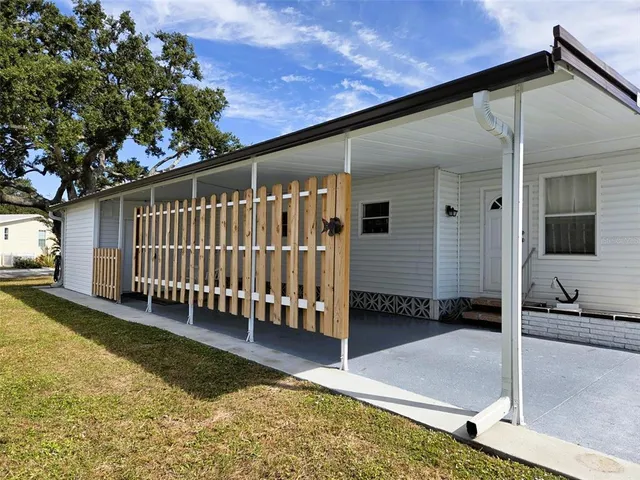 a view of a house with a yard and sitting area