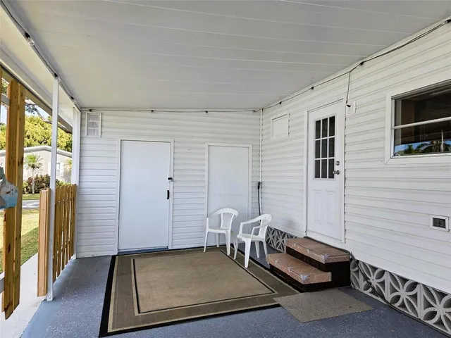 a living room with furniture a large window and a couch