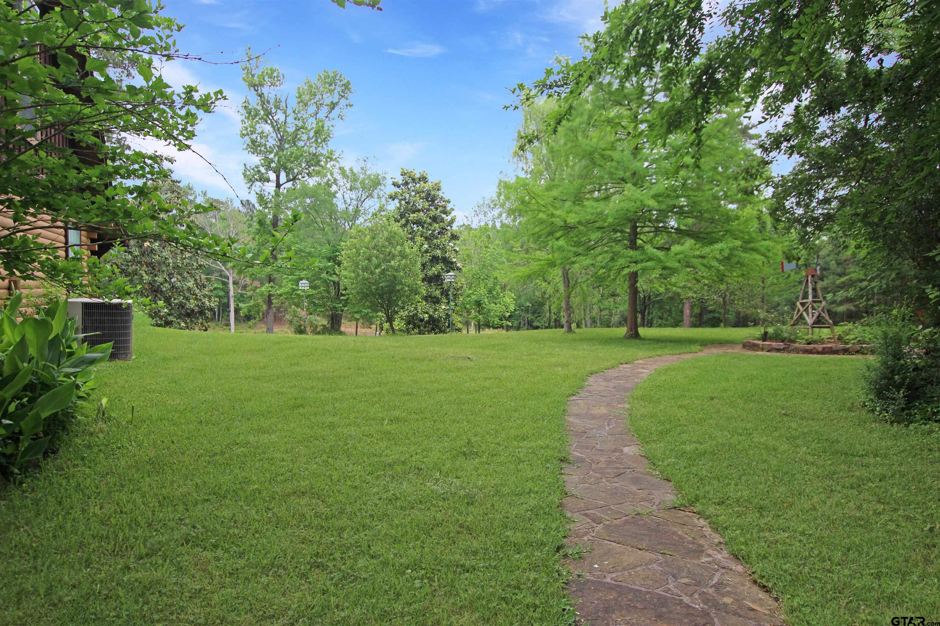 782 Rosie Wady Road Gladewater, TX 75647 - Photo 37 of 48 a view of a garden with trees