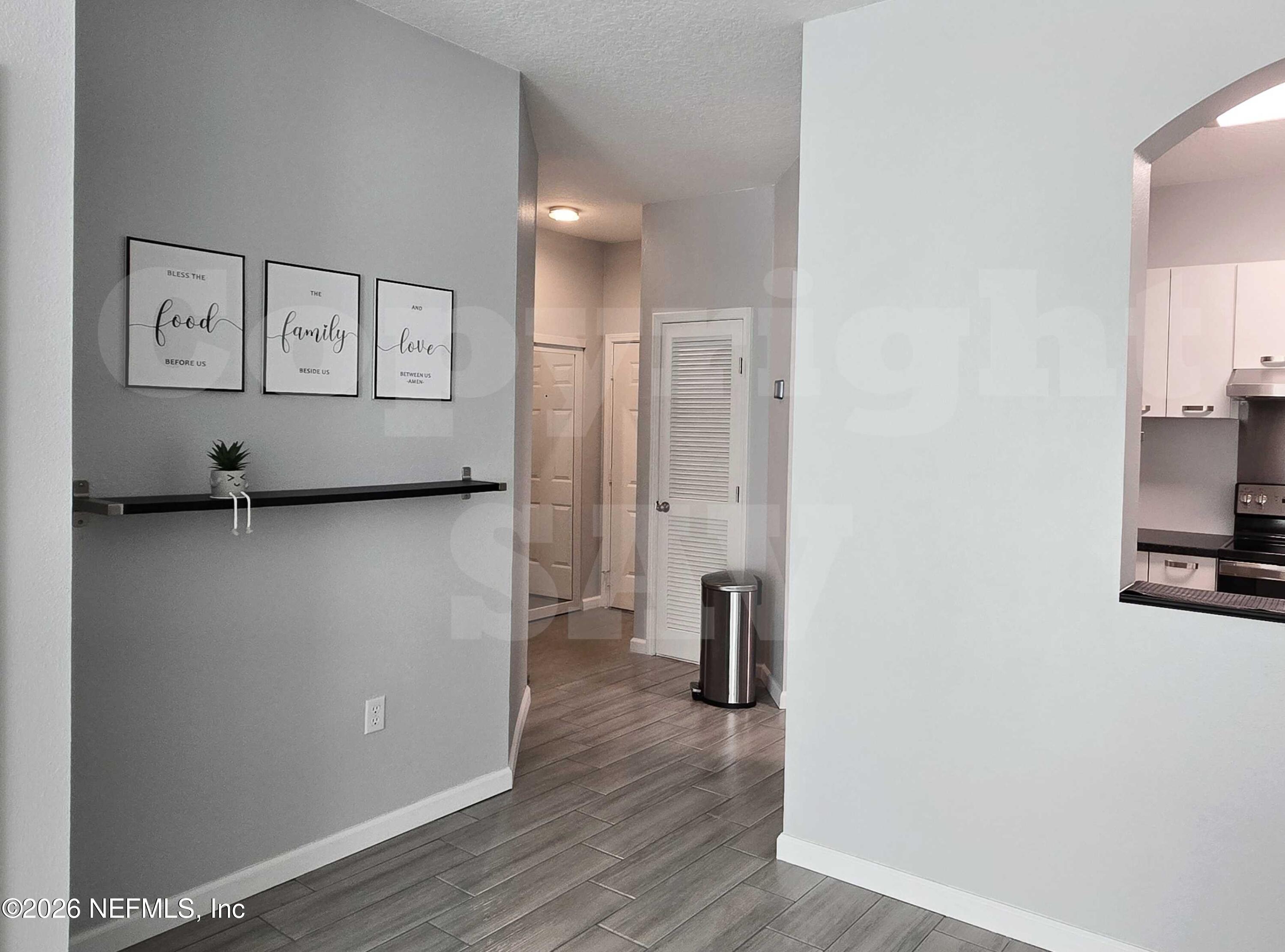 10550 Baymeadows Road, Unit 522 Jacksonville, FL 32256 - Photo 14 of 25 a view of a kitchen with fridge and wooden floor