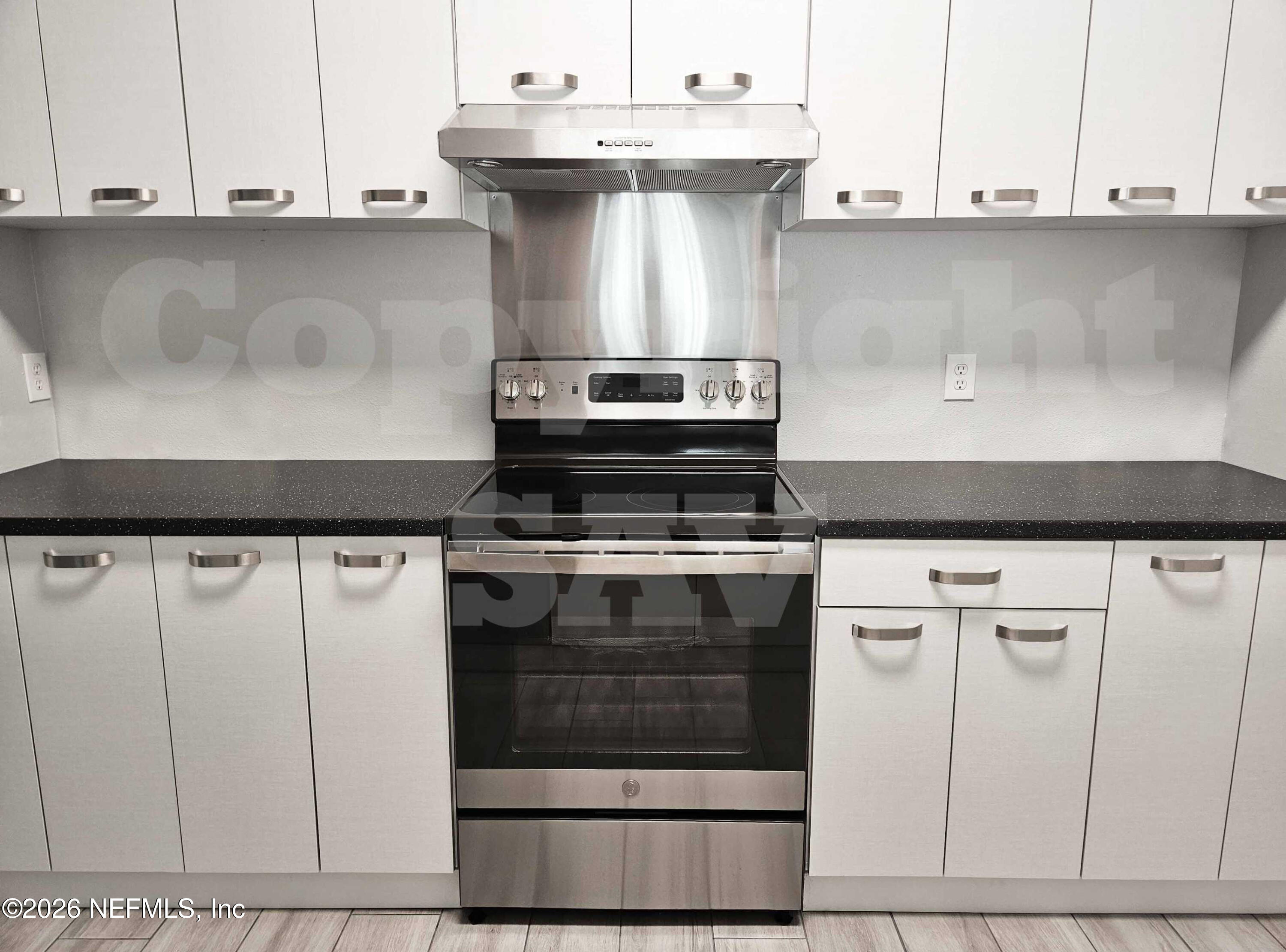 10550 Baymeadows Road, Unit 522 Jacksonville, FL 32256 - Photo 17 of 25 a stove top oven sitting inside of a kitchen