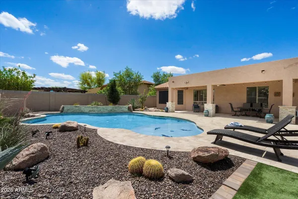 a swimming pool with outdoor seating