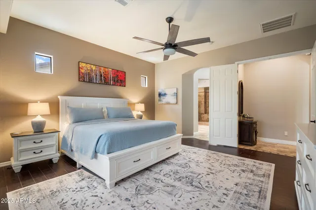 a bedroom with a bed and a chandelier