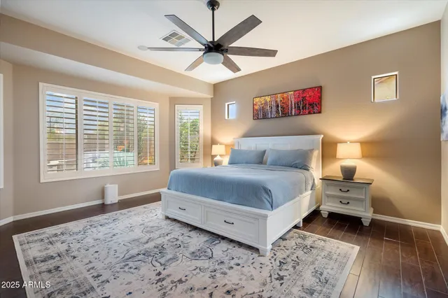 a bedroom with a bed and a large window