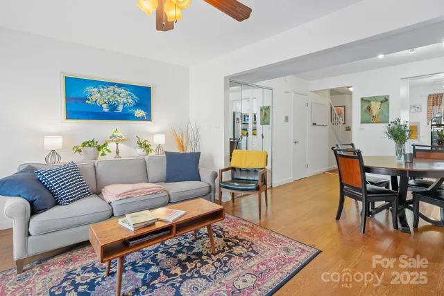 a living room with furniture wooden floor and a rug