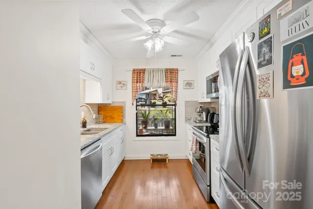 a kitchen with stainless steel appliances a refrigerator and a stove