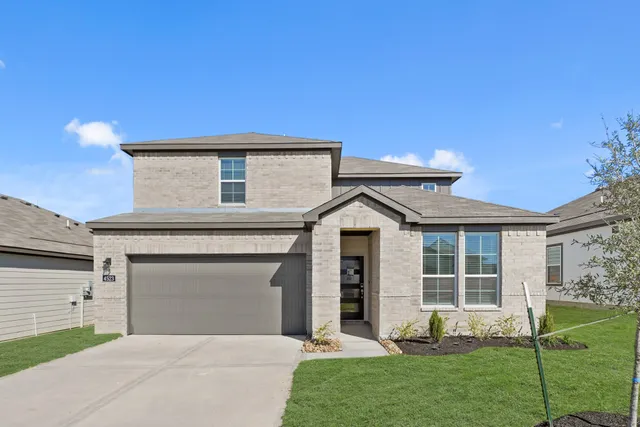 a sign that is sitting on a brick wall