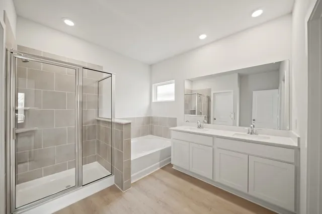a spacious bathroom with a shower sink and mirror