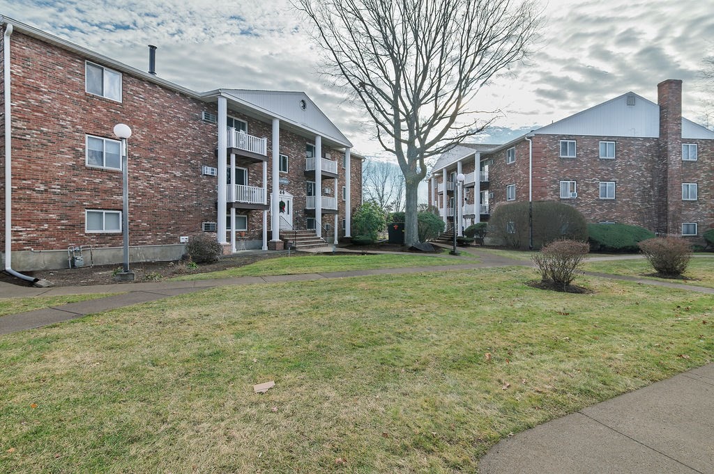 1801 Ocean Street, Unit B31 Marshfield, MA 02050 - Photo 14 of 17 a view of a brick house with a yard