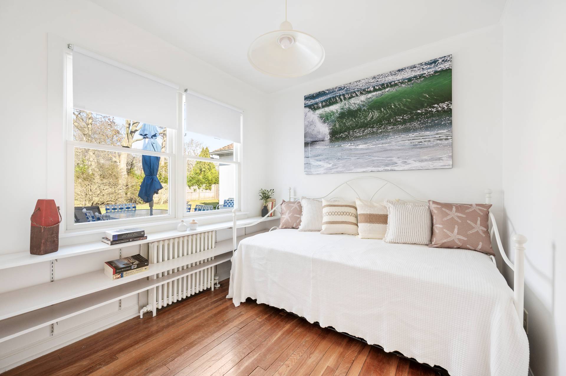 25 Lynncliff Road Hampton Bays, NY 11946 - Photo 18 of 24 a bedroom with a bed and a large window