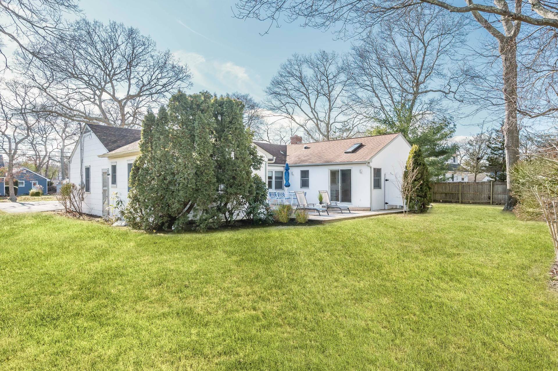 25 Lynncliff Road Hampton Bays, NY 11946 - Photo 20 of 24 a front view of a house with yard and green space