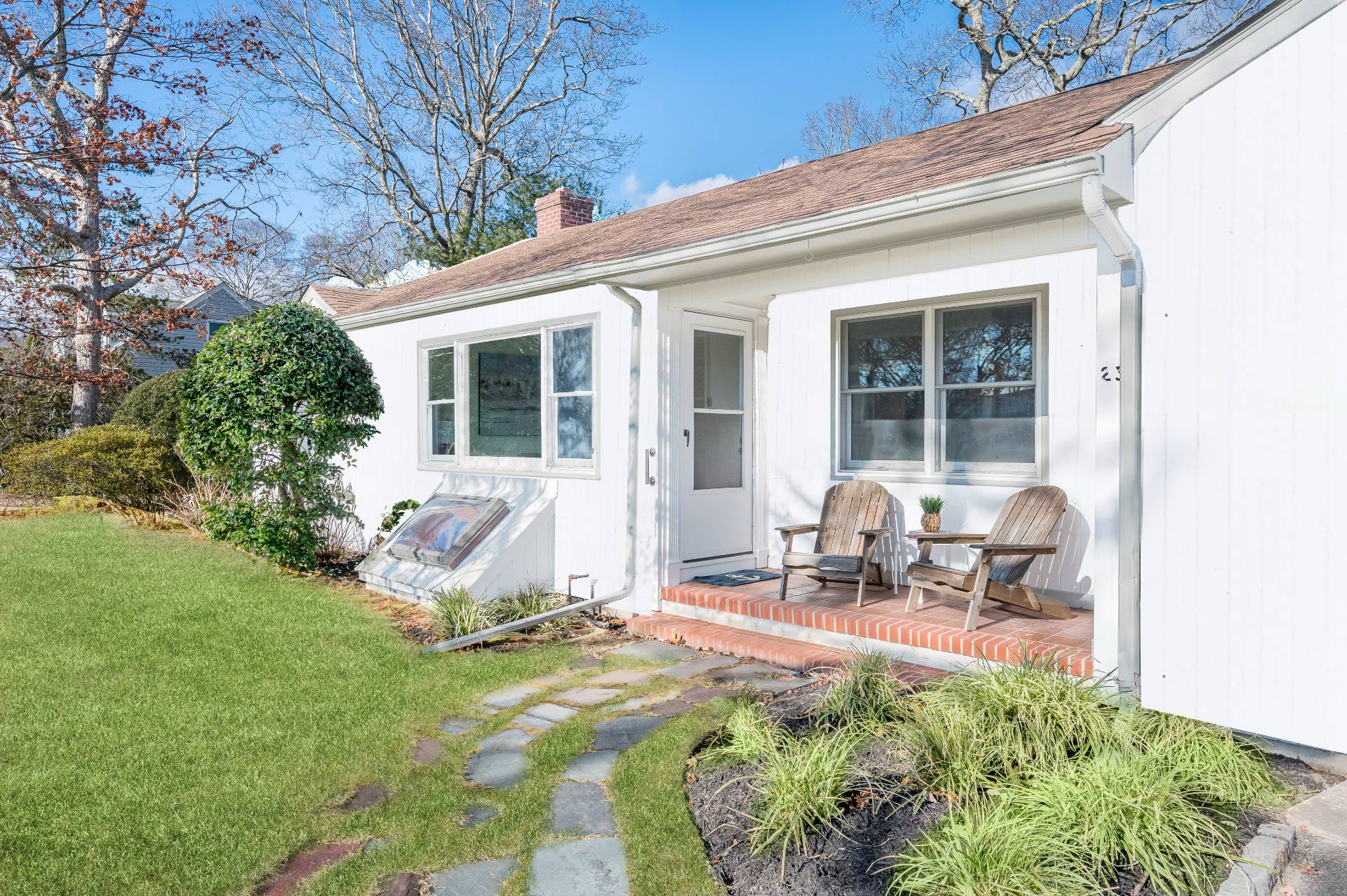 25 Lynncliff Road Hampton Bays, NY 11946 - Photo 3 of 24 a view of backyard with table and chairs and a large tree